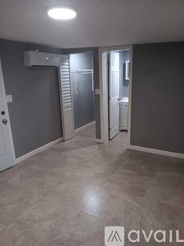 A room with a tiled floor and a white door.