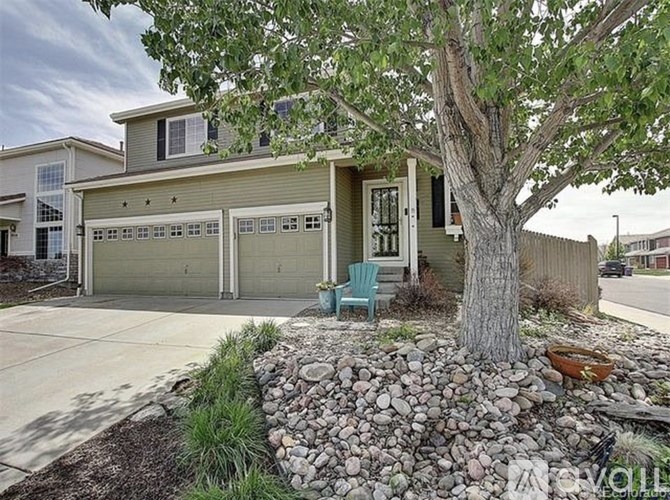 A house with a tree in front of it.
