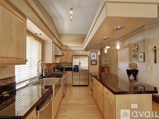 A kitchen with wooden cabinets and stainless steel appliances.