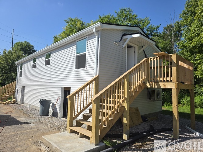 A house with a wooden deck and stairs.