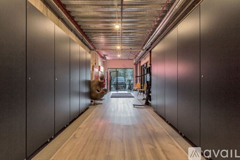A long hallway with a person walking down it.