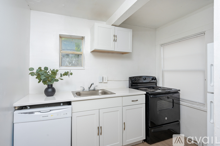 A small kitchen with a black stove top oven.