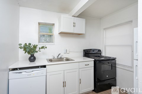 A small kitchen with a black stove top oven.