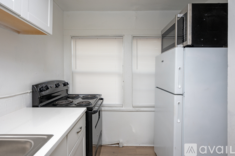 A kitchen with a stove, oven, and refrigerator.