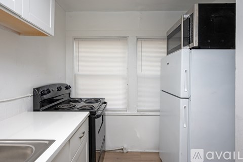 A kitchen with a stove, oven, and refrigerator.