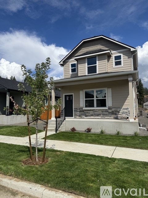 A house with a tree in front of it.