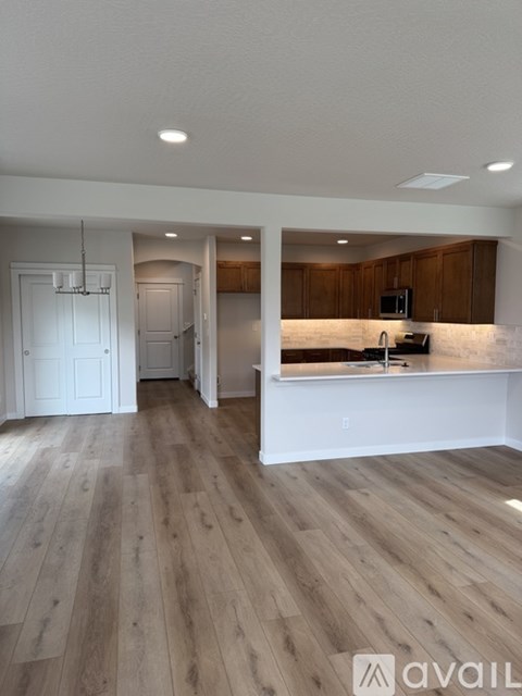 A kitchen with wooden cabinets and a white countertop.