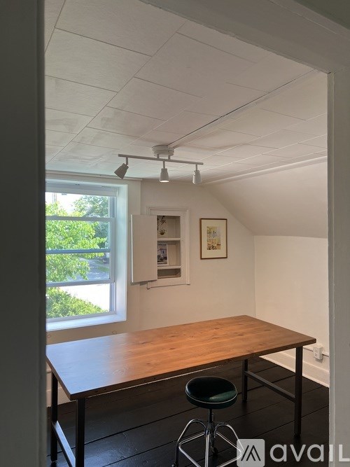 A room with a table and a window.