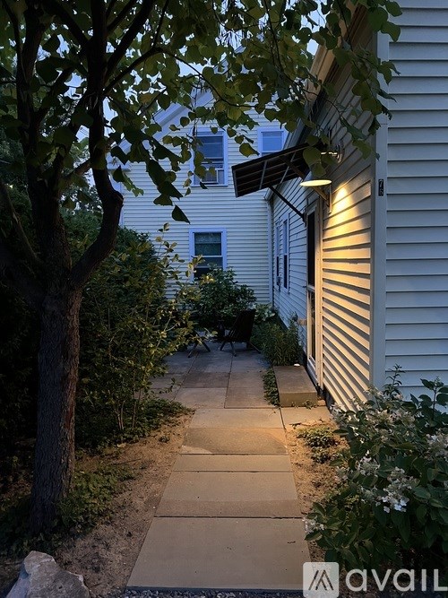 A tree is in front of a house.
