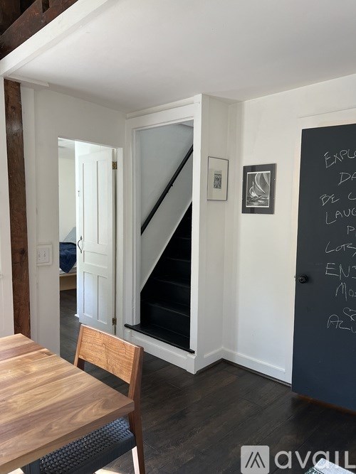 A chalkboard with writing on it is on the wall.