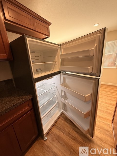A kitchen with wooden cabinets and a granite countertop.