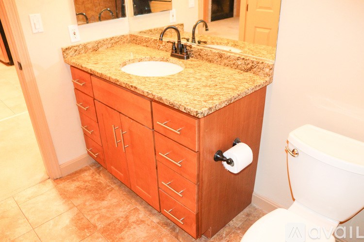 A bathroom with a sink, toilet and a counter top.