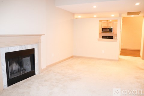 A living room with a fireplace and a television above it.