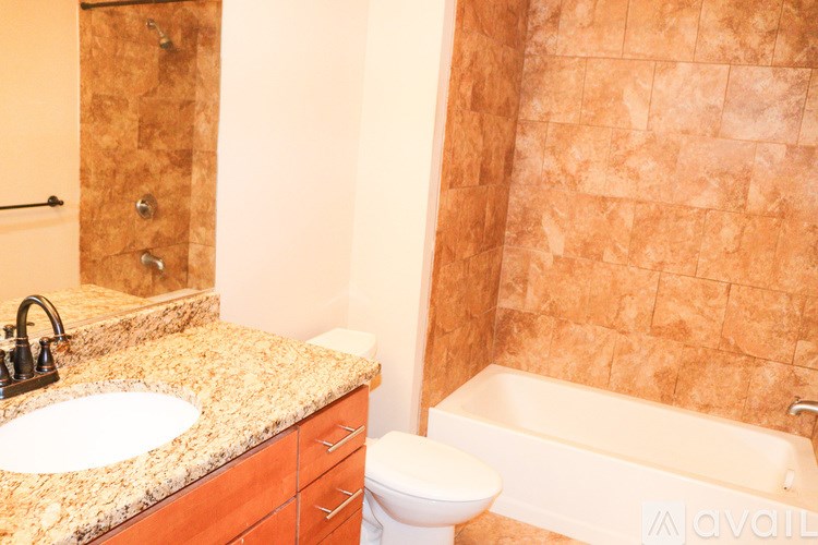 A bathroom with a sink, toilet and bathtub.