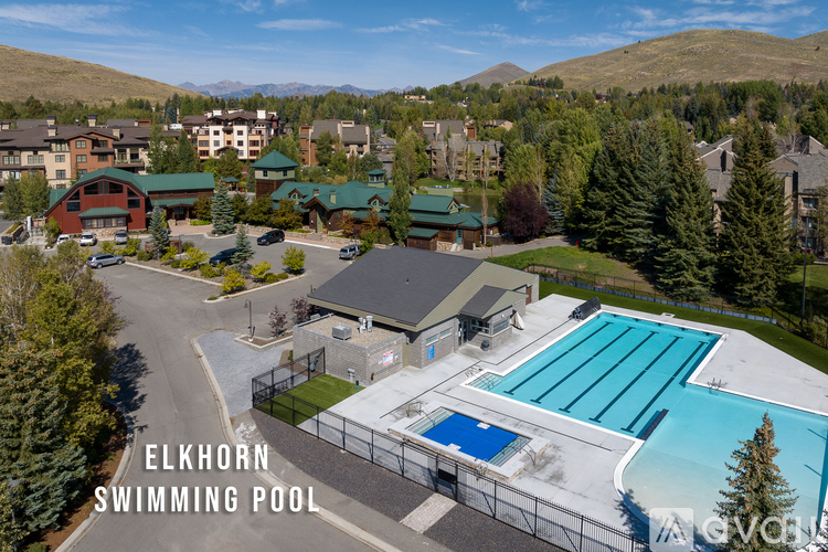 A large swimming pool surrounded by a fence with the words Elkhorn Swimming Pool written on it.
