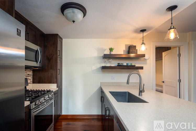 A kitchen with a stove top oven and a sink.