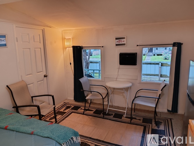 A living room with a couch, chair, and television.