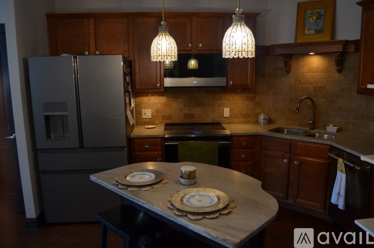 A kitchen with a table set for two.