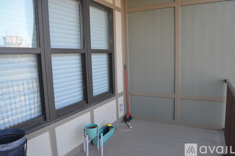 A room with a window and a broom.