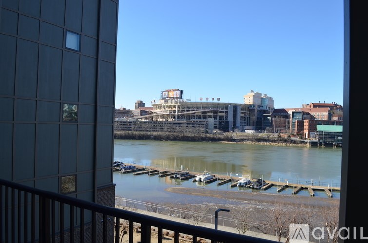 A view of a river with boats docked and buildings in the background.
