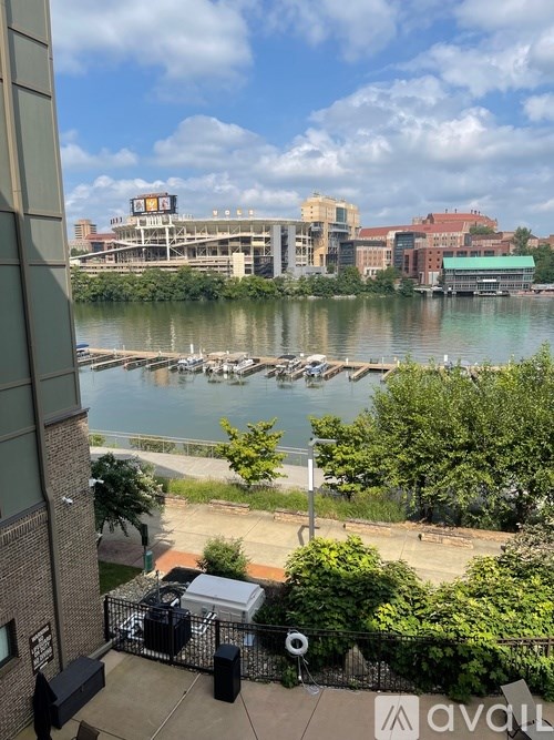 A walkway with a bench and a river in the background.