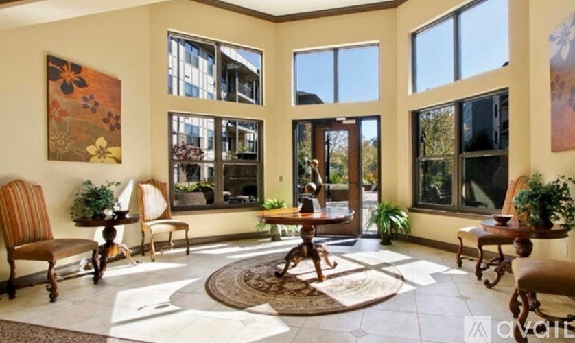 A living room with a rug and chairs.