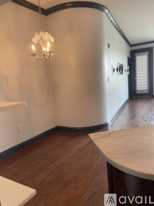 A man stands next to a pantry with a lot of food items.