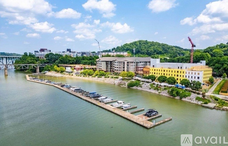 A large body of water with a dock and a building in the background.