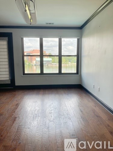 A living room with a black couch and a coffee table.