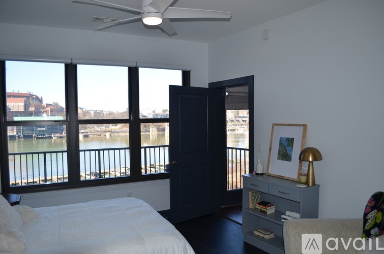 A bedroom with a large bed and a view of the water.