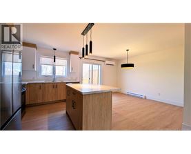 A kitchen with wooden cabinets and a countertop is shown.