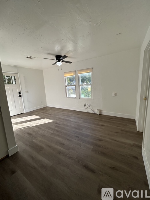 A hallway with a door on the right and a wall on the left.