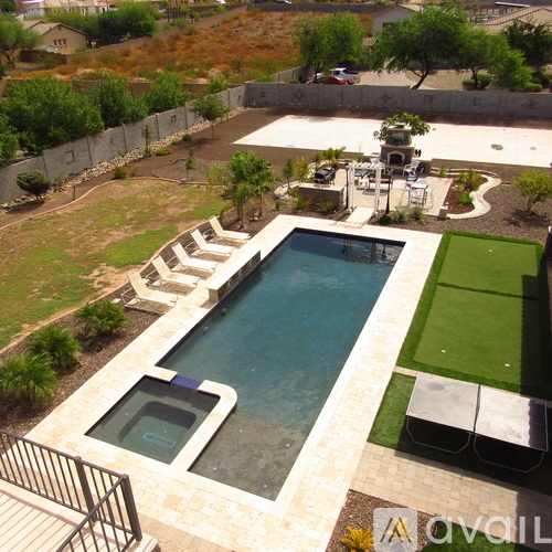 A pool with a slide and a hot tub.