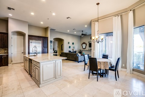 A kitchen with a table and chairs in the middle of the room.