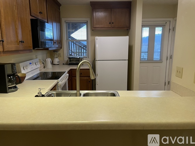 A kitchen with a sink and a refrigerator.