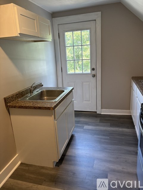 A kitchen with a sink and a window.