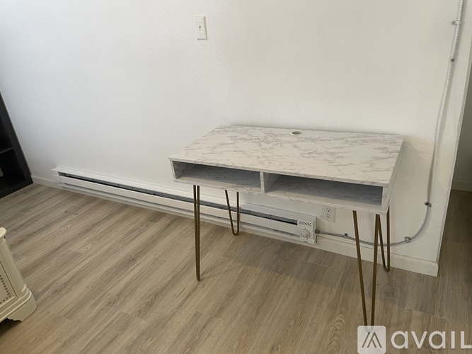 A white marble countertop with a white cabinet underneath it.
