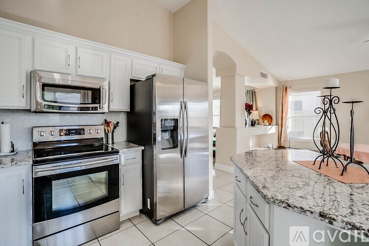 A kitchen with a stainless steel refrigerator and oven.