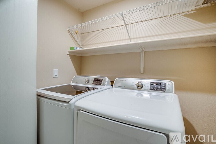 A washer and dryer are sitting next to each other in a small room.