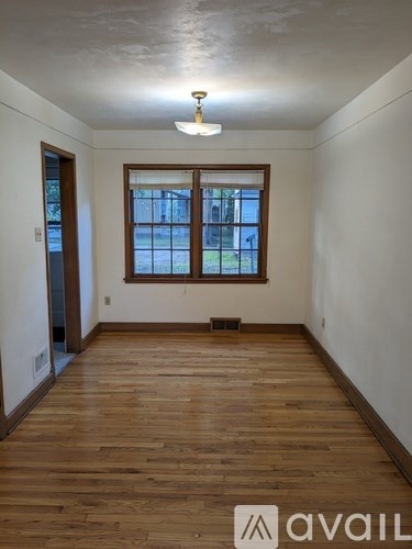 A room with wooden floors and a window.