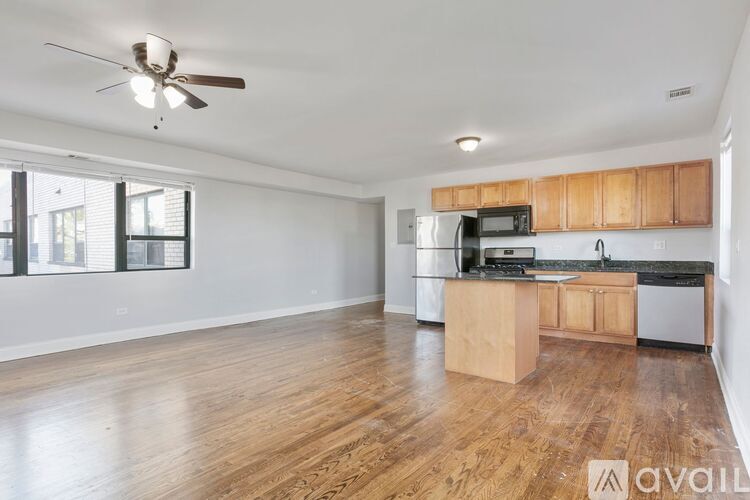 A kitchen with wooden cabinets and a ceiling fan.