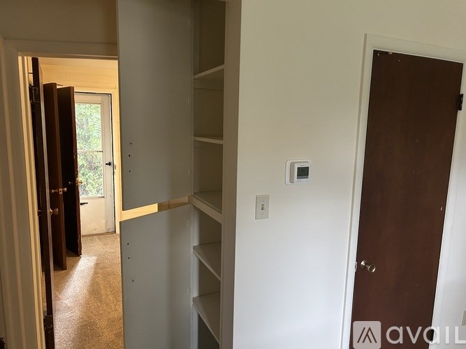 A white door with a brown frame is on the right side of the image.