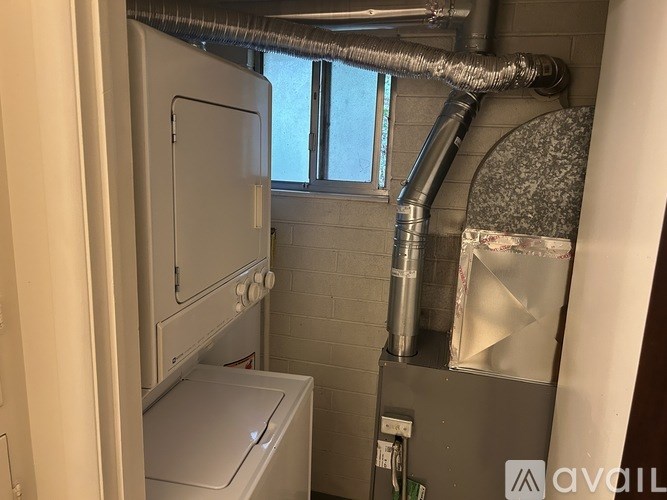 A small laundry room with a washer and dryer.