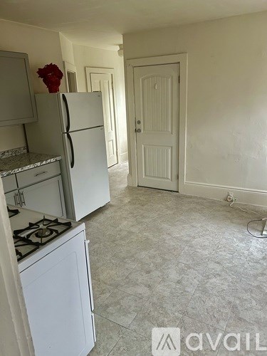 A kitchen with a white fridge and a white stove top.