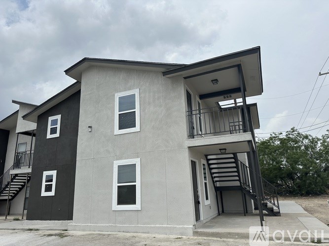 A two-story house with a balcony on the second floor.