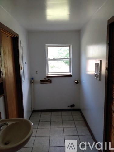 A bathroom with a sink and a window.