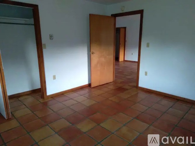 A house with a white door and a ramp leading to it.