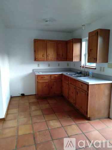 A room with wooden floors and a green cabinet.