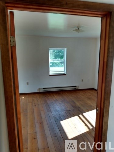 A room with wooden floors and a window.