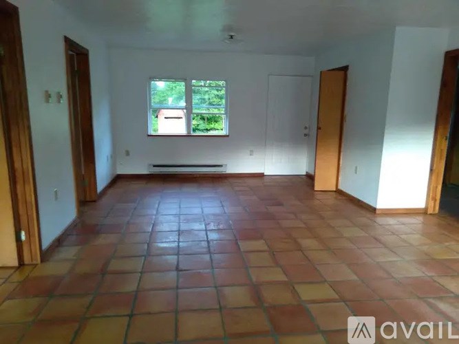 A room with wooden floors and a white door.